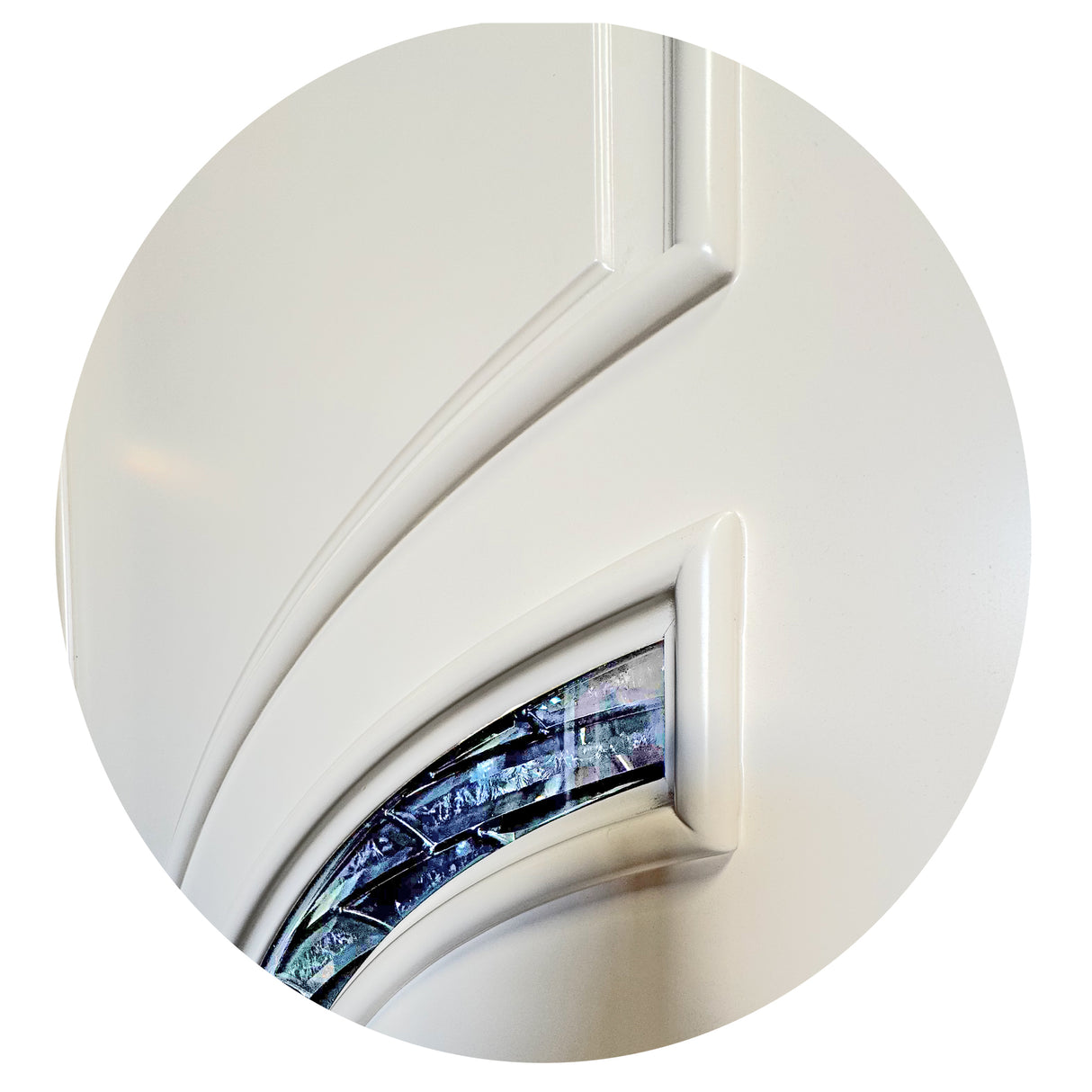Detailed close-up of crescent-shaped glass panels on white front door highlighting design and texture