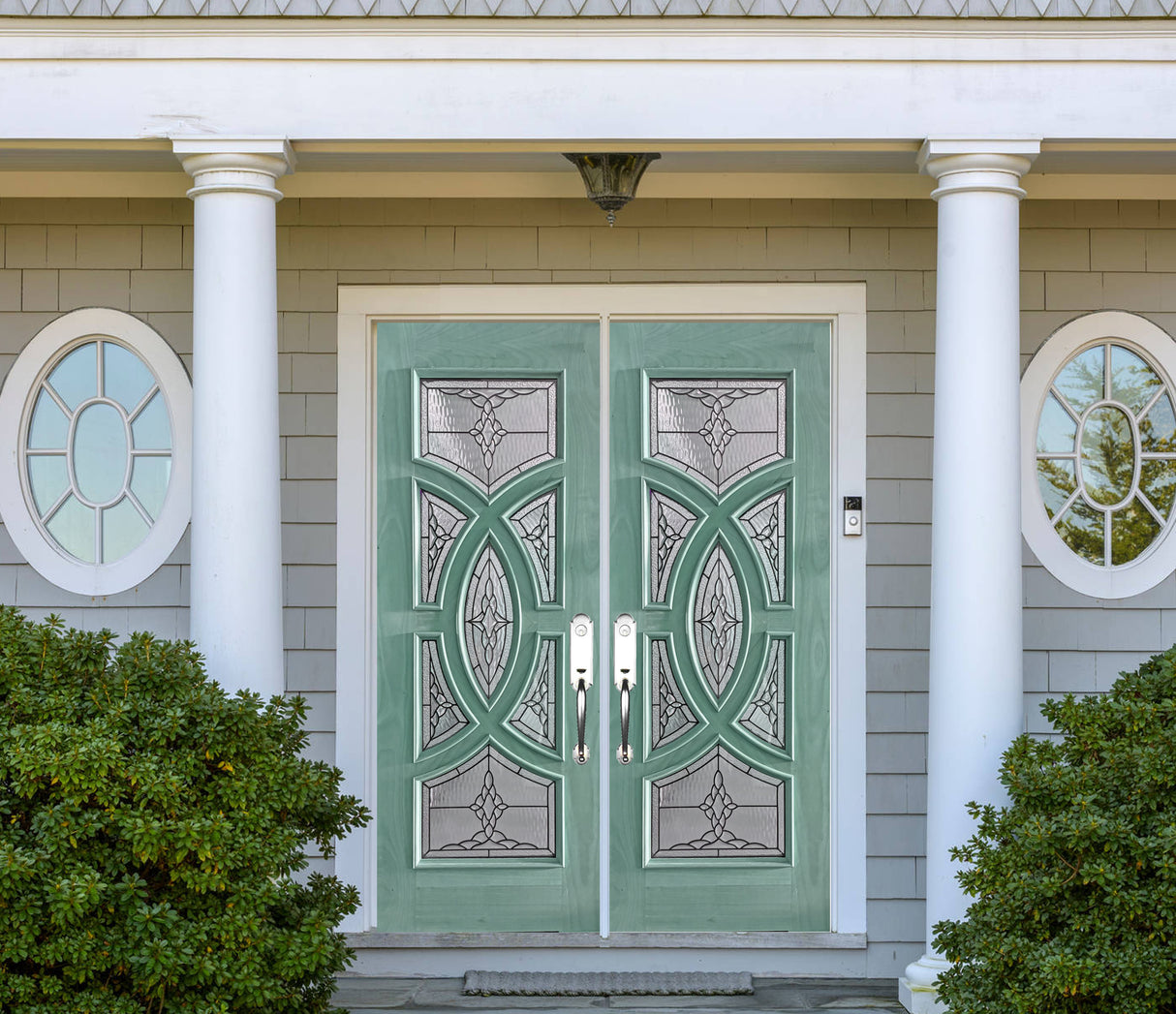 Double solid wood entry doors with decorative panel layout green