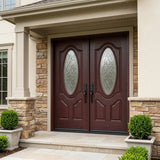 Fiberglass double front entry door installed on home exterior with decorative oval beveled glass panels