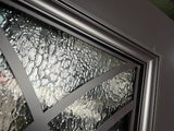 Close-up of decorative glass and iron frame detail on double front entry door