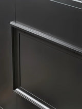 Close-up of raised panel and black metal finish on iron double front entry door