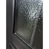 Close-up of textured glass panel on iron double front entry door with black metal grid