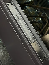 Close-up of black iron door frame and edge construction on double front entry door