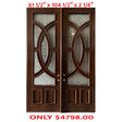 A pair of exterior wooden double doors with decorative glass panels