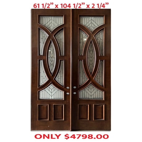 A pair of exterior wooden double doors with decorative glass panels
