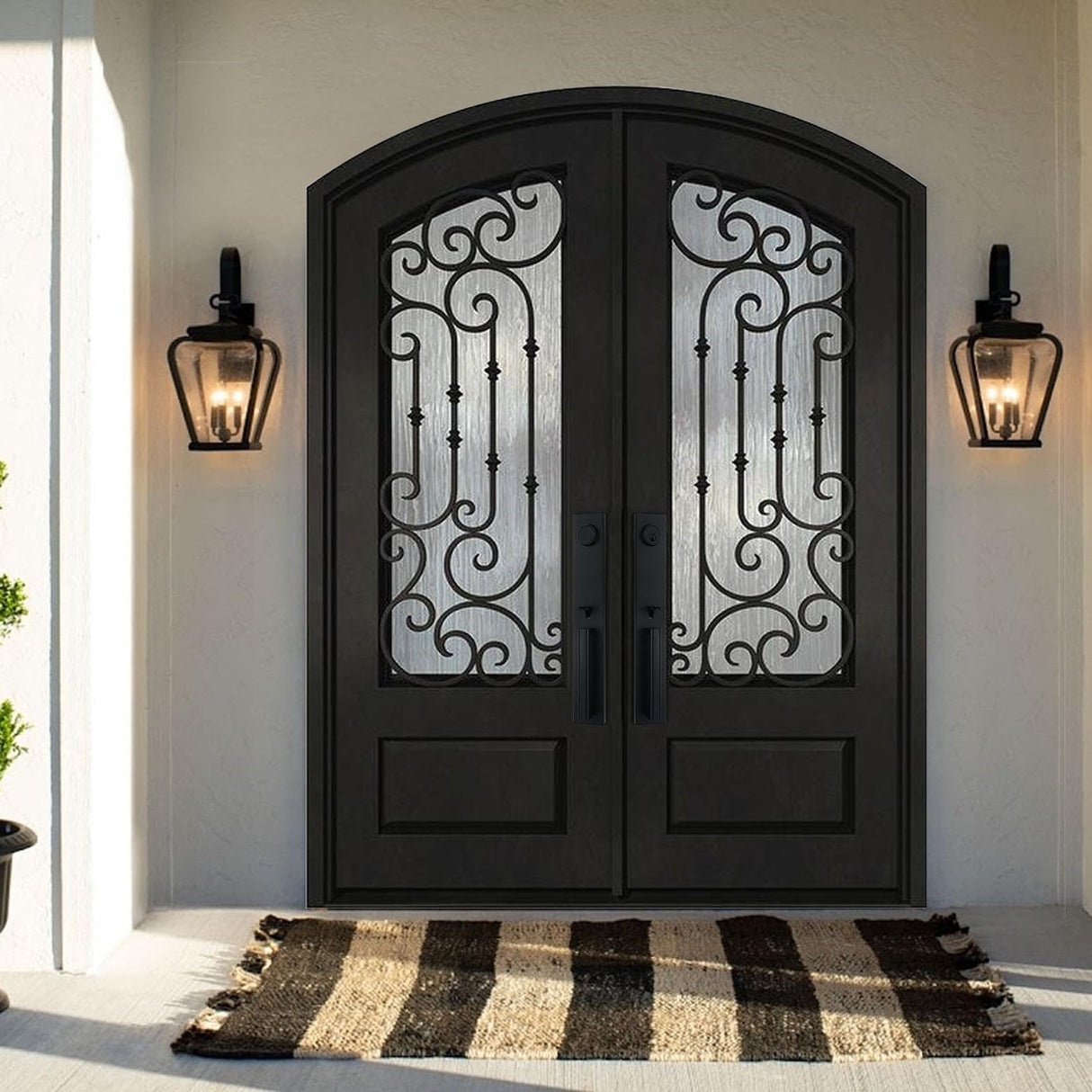 Black arched double iron front door with decorative glass panels