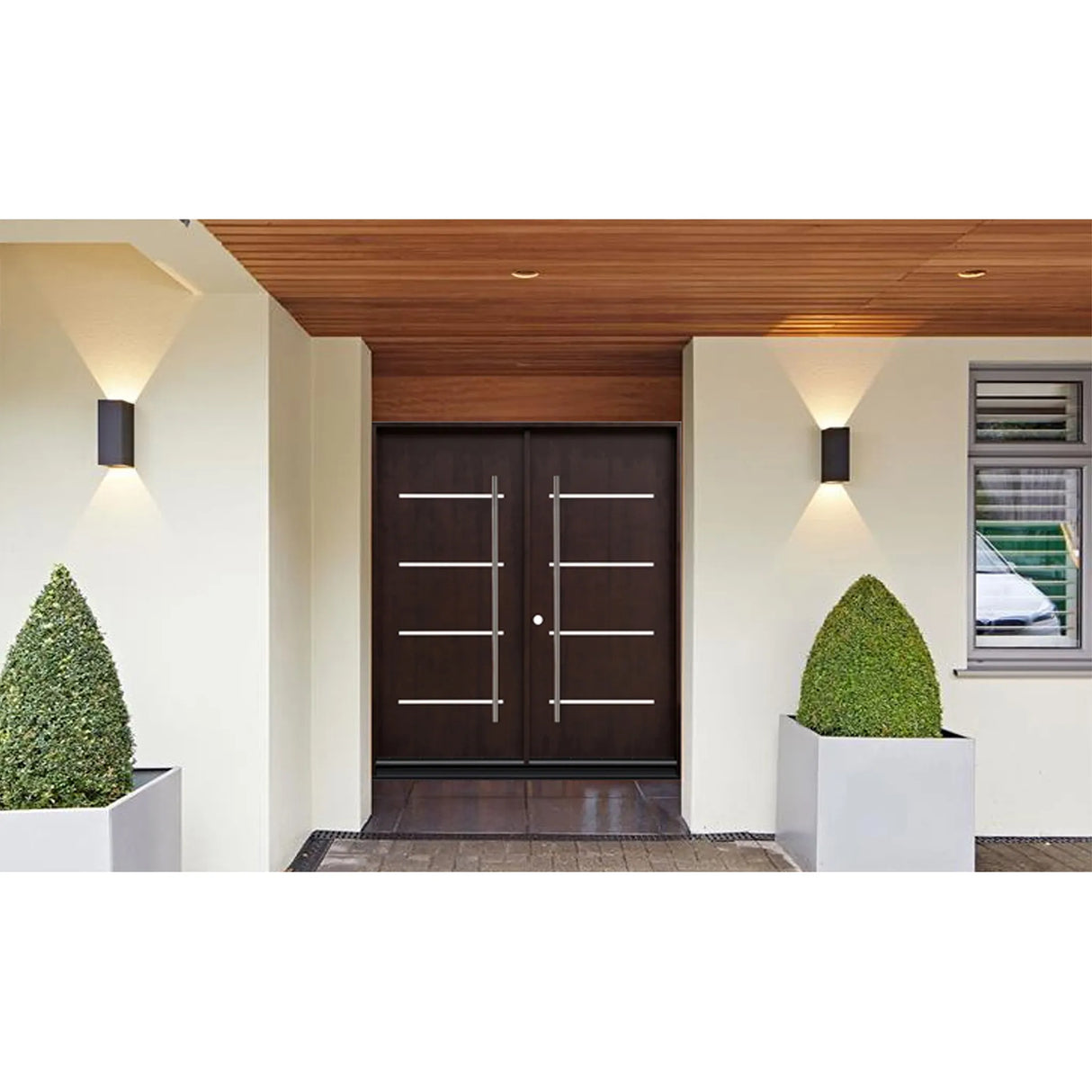 Double front entry door installed on home exterior with wood finish and modern panel design