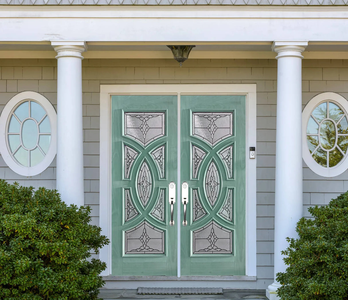 Double solid wood entry doors with decorative panel layout green