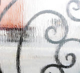 Close-up of textured rain glass panels on iron double front door showing privacy glass detail