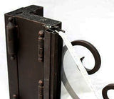 Detailed top portion of iron double door showing glass panel integration within steel frame