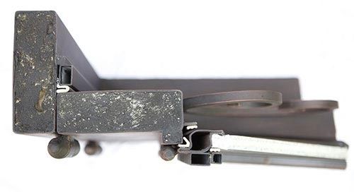 Close-up of top section of black iron door frame highlighting heavy-duty steel construction and finish