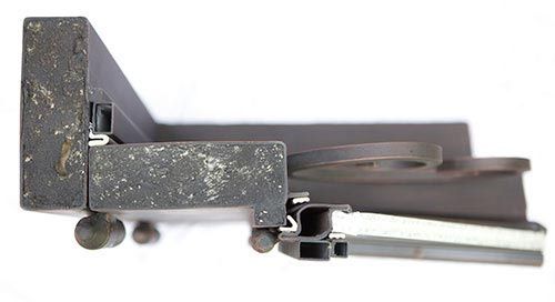 Close-up of top iron door frame showing heavy-duty steel construction and black finish on double entry