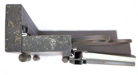 Close-up of top iron door frame showing heavy-duty steel construction and black finish on double entry